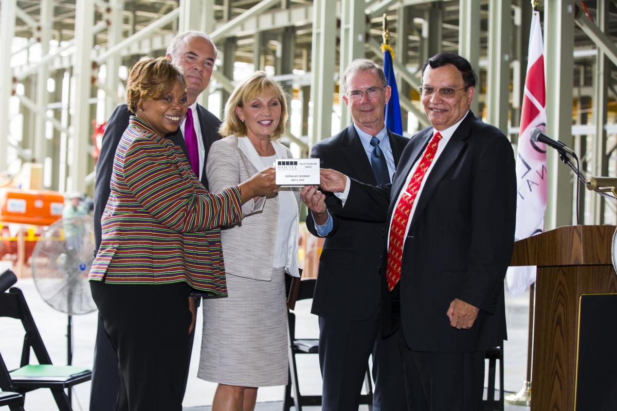 Topping-off Ceremony Keynote Speakers Together Raise a Miniature Version of a Steel Girder From Left to Right: Camden Mayor Dana Redd; Commissioner Bob Martin (NJ Department of Environmental Protection); NJ Lt. Governor Kim Guadagno; Mr. William Levis (President and COO of PSEG); Dr. Kris Singh (President and CEO of Holtec)